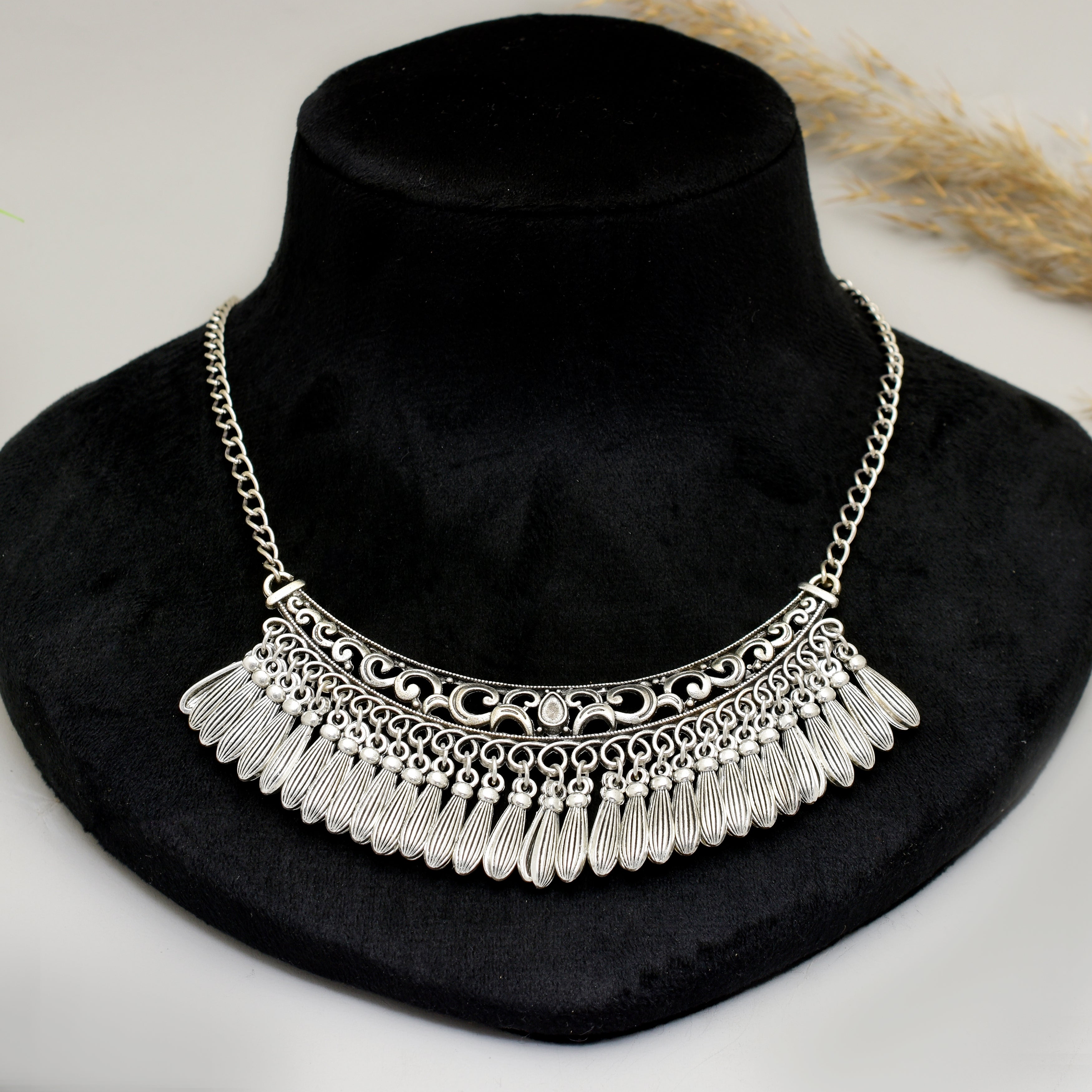 Handcrafted Silver Oxidised Tribal Crescent Bib Choker Necklace with Intricate Geometric Filigree Cut-outs and Textured Feathered Tasselled Drop Hangings for Women and Girls